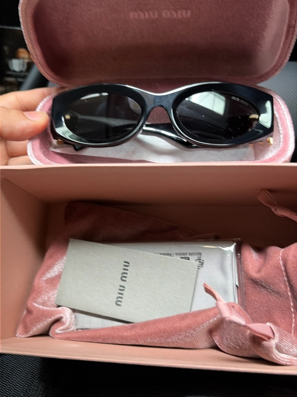 Miu Miu Black Oval Sunglasses with Gold Accents